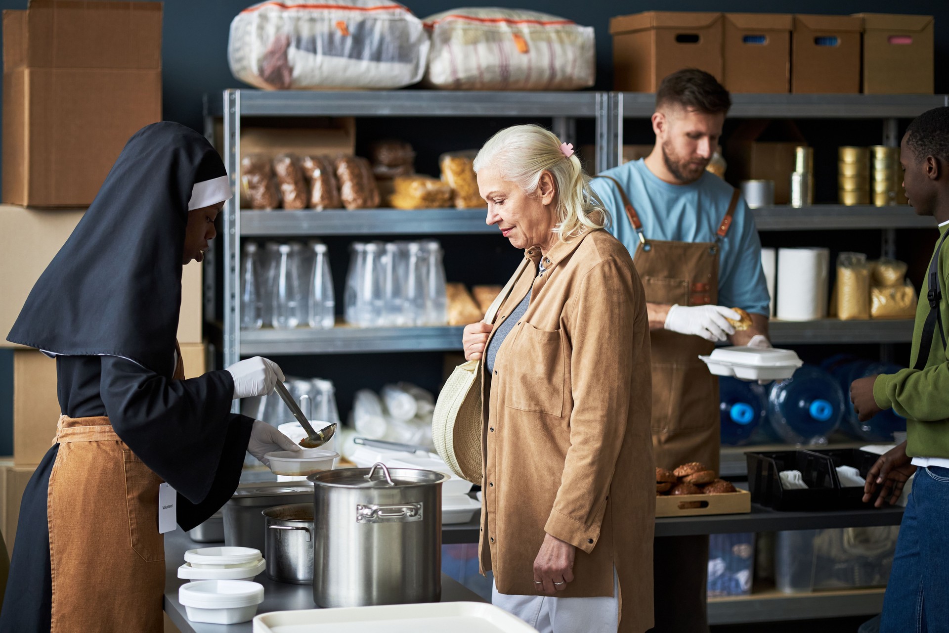 Volunteers Preparing Meals in Community Kitchen Setting