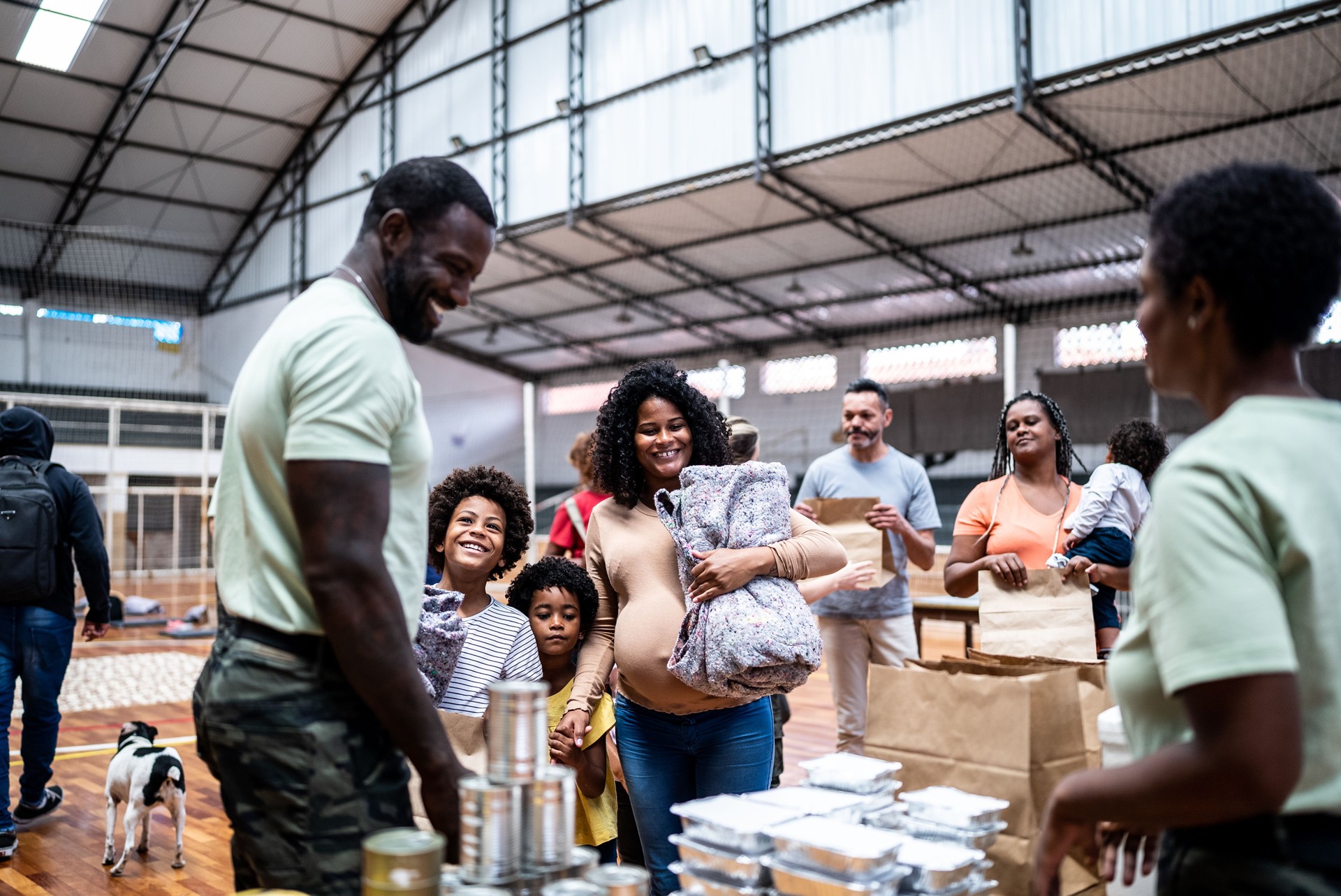 Refugee family getting a donation in a sheltering