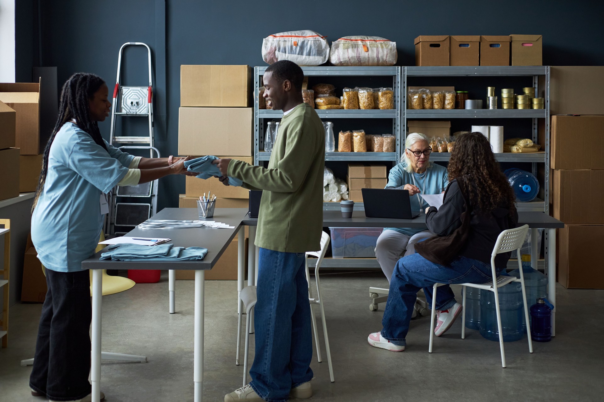 Diverse Group Discussing Work in Storage Room Setting